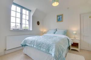 Postel nebo postele na pokoji v ubytování The Coach House