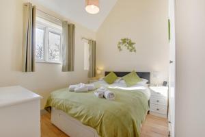 una camera da letto con un letto con asciugamani sopra di Teign Cottage a Broadhempston Altre 8 foto
