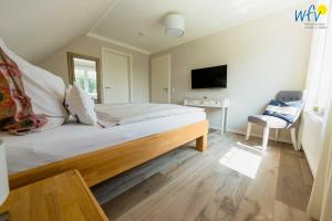 Voodi või voodid majutusasutuse Ferienhaus Melkerpad 28 Ferienwohnung Inselzauber toas