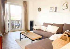 a living room with a couch and a table at Havnkoje 2 in Westerbergen