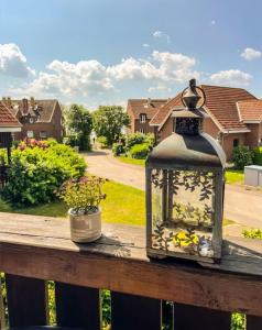 a lantern sitting on top of a wooden rail at Havnkoje 2 in Westerbergen