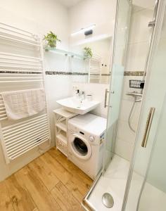 a bathroom with a washing machine and a sink at Havnkoje 2 in Westerbergen +22 photos