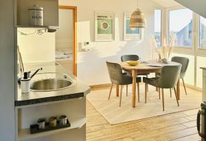 a kitchen and dining room with a table and chairs at Havnkoje 2 in Westerbergen