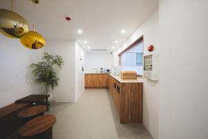 a kitchen with wooden cabinets and a counter top at DadamHotel in Suwon
