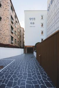 a cobblestone street in front of two buildings at DadamHotel in Suwon