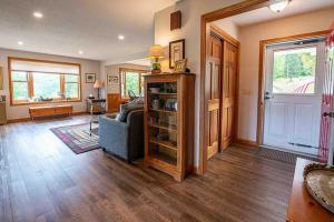 a living room with a blue couch and a door at Robbins' Mountain Retreat in West Thornton