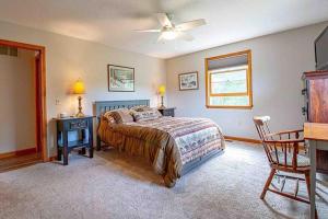 a bedroom with a bed and a table and a chair at Robbins' Mountain Retreat in West Thornton