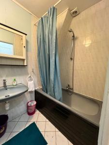 a bathroom with a tub and a sink and a shower at Bright flat near Paris, close to metro in Ivry-sur-Seine