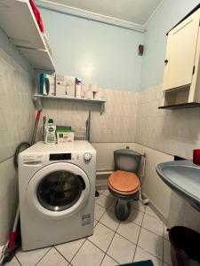 a small bathroom with a washing machine and a toilet at Bright flat near Paris, close to metro in Ivry-sur-Seine