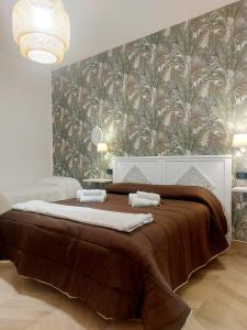 a bedroom with a large bed with a brown blanket at B&B La Rotonda in Naples