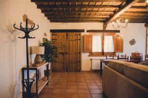 a living room with a couch and wooden ceilings at Casa Rural La Vega Piscina, naturaleza y vistas in San Vicente de Alcántara
