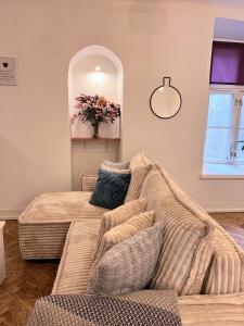 a living room with a couch and a mirror at Reval Residences Old Town in Tallinn