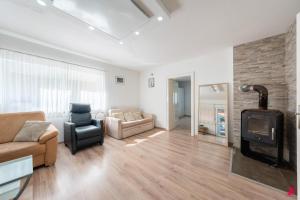 a living room with a couch and a fireplace at Ferienwohnung Los Amigos in Thiersee
