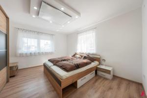 a bedroom with a large bed in a white room at Ferienwohnung Los Amigos in Thiersee