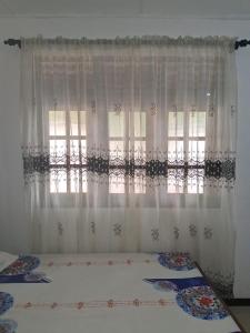 a bed in a room with a window at Golden Gate Ways Villa in Hikkaduwa