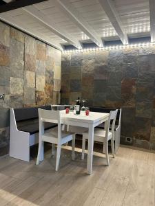 a white table and chairs in a room at Casaldo in Gardone Riviera
