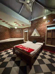 a bedroom with a large bed in a brick wall at Nirvikalpa vagamon in Vagamon