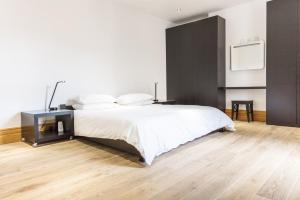 a bedroom with a bed and a tv on a wall at Seaview Penthouse 1 in Alnmouth