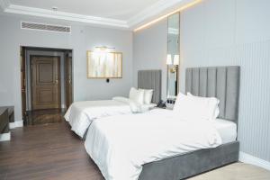 une chambre d'hôtel avec deux lits et un miroir dans l'établissement Faletti's Boutique Multan by The Windsor Group, à Multan