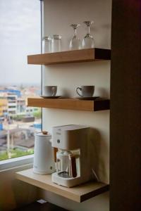 a coffee maker on a shelf with a window at Anqari Hotel in San Antonio +20 photos