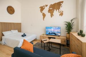 a bedroom with a bed and a tv and a couch at Escape Studio ! Cozy & practical in Seclin Center in Seclin