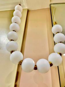 Un grupo de luces blancas colgando de una pared. en Royal Empire, en Abuja