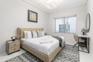 a white bedroom with a large bed and a window at Trinity Holiday Homes - Sheikh Zayed Road Near to Financial Center Metro Station in Dubai +177 photos