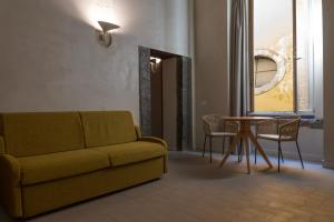 a living room with a couch and a table at Dal Console Rooms in Naples