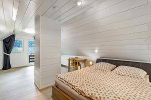 a bedroom with a bed and a wooden wall at Haus Waldesruh in Medebach