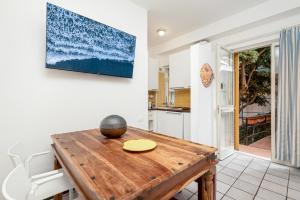 a kitchen with a wooden table in a room at CasaSolemare Terrace seaview AC in Portovenere +19 photos