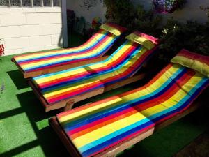 a group of colorful benches sitting on the grass at Pride Lodge in Blackpool