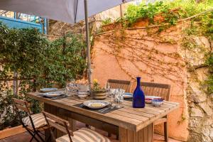 a wooden table with a blue vase on it at CasaSolemare Terrace seaview AC in Portovenere