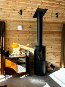 a fireplace in a room with a wooden wall at Mountain Cabin With Panoramic Views In Valdres in Bruflat