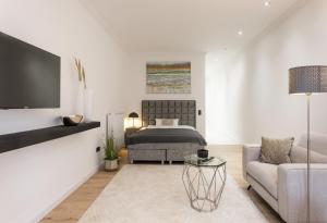 a bedroom with a bed and a couch and a tv at Ferienwohnung Salinenparc Design Budget Hotel in Erwitte