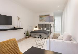 a living room with a bed and a couch at Ferienwohnung Salinenparc Design Budget Hotel in Erwitte