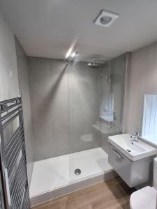 a bathroom with a shower and a toilet and a sink at The Wee Anchor in Arbroath