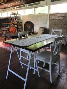 a table and chairs in a room with a fireplace at Loft en el quincho in Ingeniero Maschwitz
