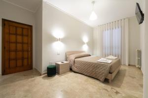 a bedroom with a bed and a door in it at B&B Storie di famiglia in Frascineto