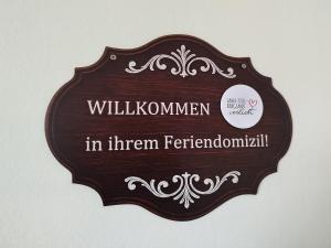 a wooden sign that reads willuminati in them ferdinand at Haus am Aartalsee in Bischoffen