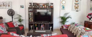 ein Wohnzimmer mit Flachbildfernseher in der Unterkunft Casa cerca a la playa in Mala
