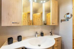 a bathroom with a sink and a mirror at Haus Stanek in Willingen +25 photos