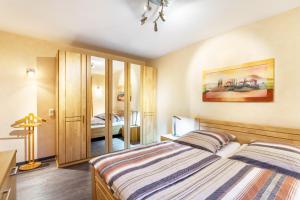 a bedroom with a bed and a mirror at Haus Stanek in Willingen