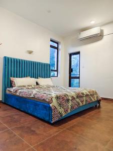 a bedroom with a bed with a blue headboard at Zahra Paradise in Mombasa