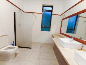 a bathroom with a toilet and a sink and a shower at Zahra Paradise in Mombasa +13 photos
