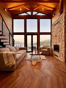 a living room with a couch and a table at Mountain Log Cabin in Mavrovo +72 photos