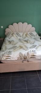 a bed with a comforter on top of it at Appartement Lanton in Lanton