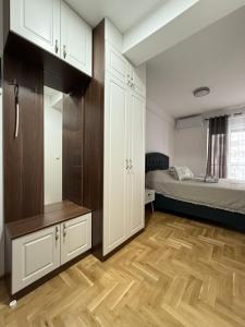 1 dormitorio con armarios blancos y 1 cama en Apartman Banjac, en Vrnjci 10 fotos más
