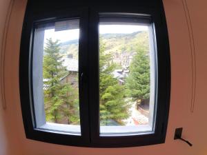 a window with a view of a city at Soldeu Paradis La Solana in El Tarter