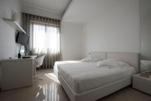 Postel nebo postele na pokoji v ubytování Pietre Nere Resort & Spa