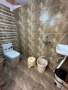 a bathroom with a toilet and a sink at Ahmed's Guest House in Hyderabad +7 photos